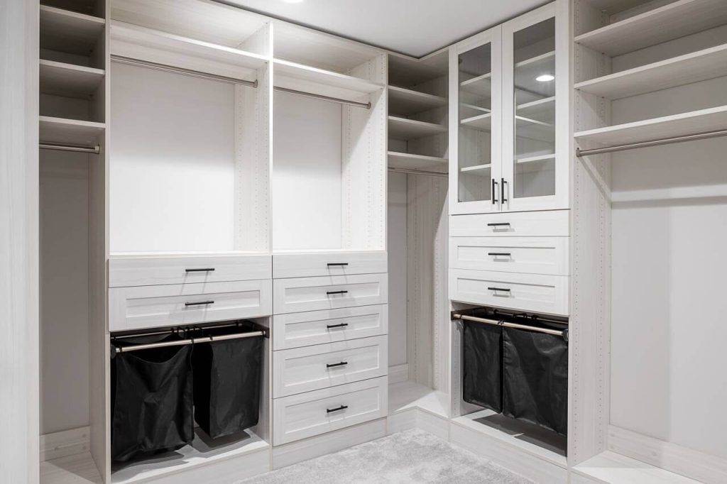 custom walk in closet with storage and drawers