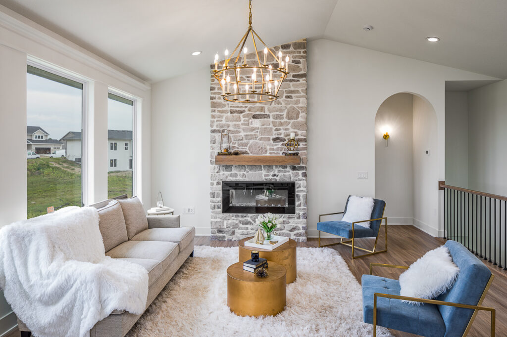 Bright open living room with a stone fireplace