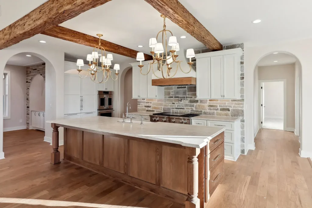 A kitchen island features decorative wooden pillars on the front side