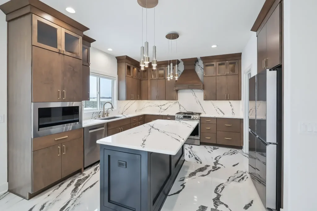 A three-sided kitchen layout featuring wood cabinets, appliances, and an island in the middle