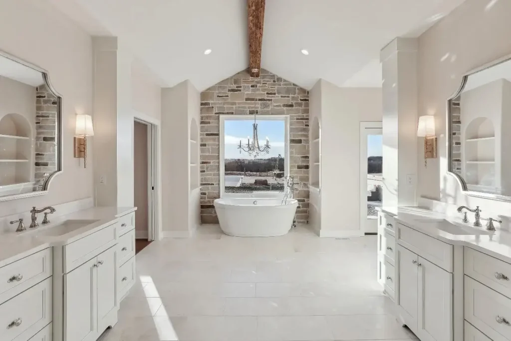 A stone-patterned accent wall serves as the backdrop to a luxurious soaker tub in this bathroom