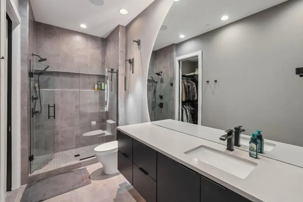 A large backlit bathroom mirror