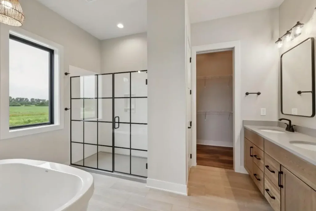 A glass shower door with a pattern of black lines creating a window-pane design