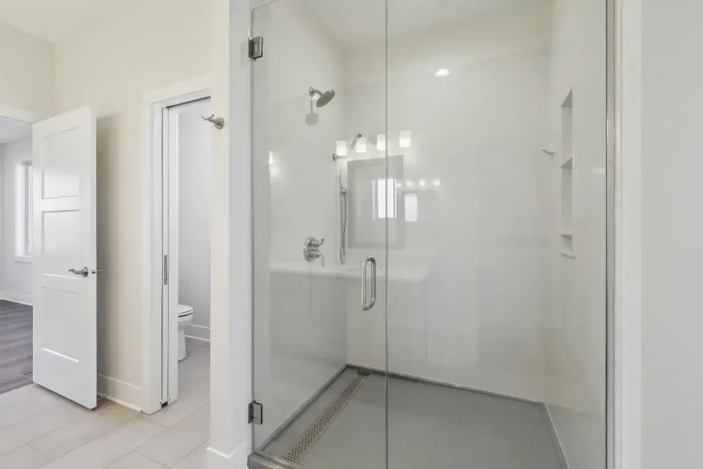 An onyx shower with a clean, white-colored interior