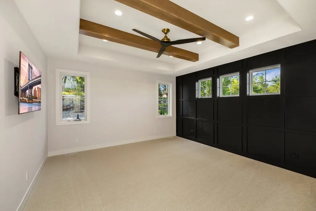 A newly built modern bedroom featuring a black accent wall