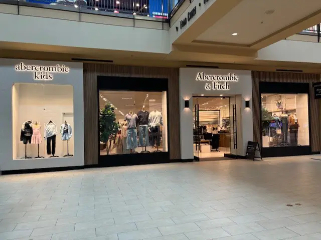 Retail storefront featuring Abercrombie & Fitch and Abercrombie Kids in a clean, modern mall setting. Bright displays and open entrances make the space inviting and easy to browse.